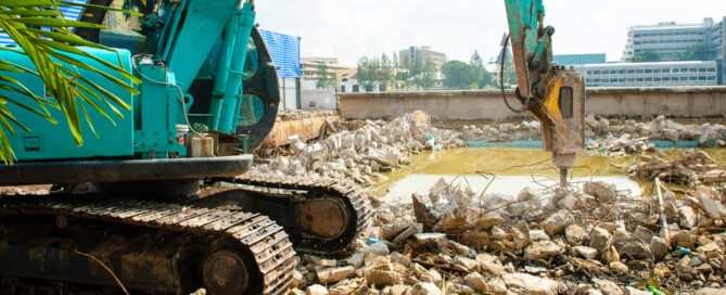 Backhoe Demolishing Old Swimming Pool